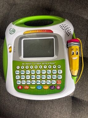Leap Frog tablet. Various features. Battery operated. Attached pencil.